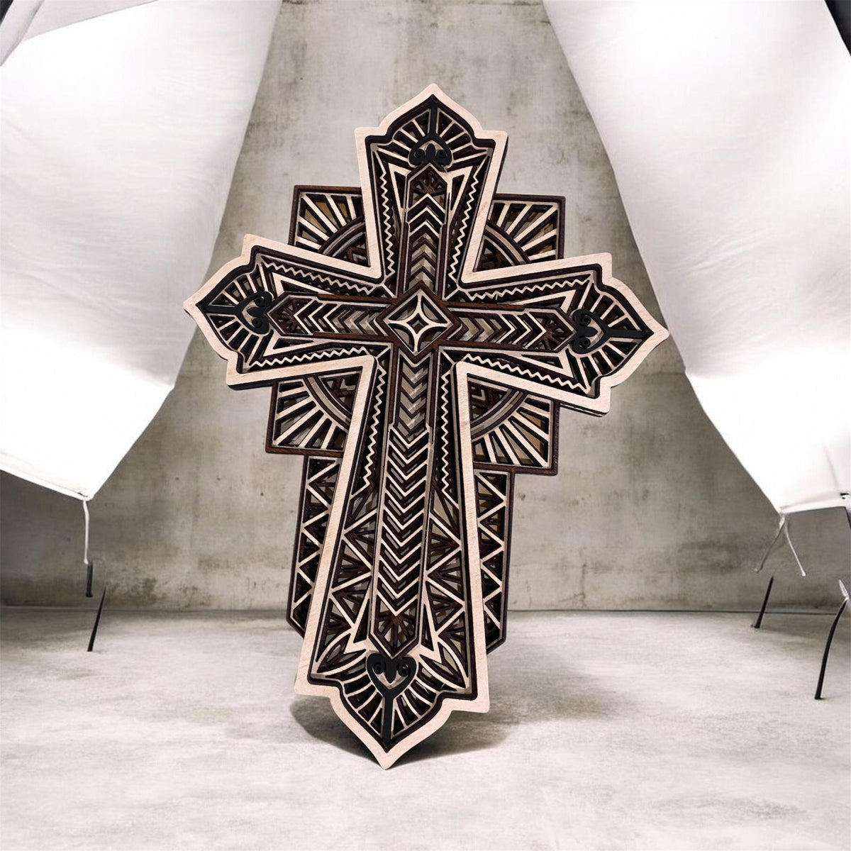 Handcrafted layered wood cross with intricate geometric patterns